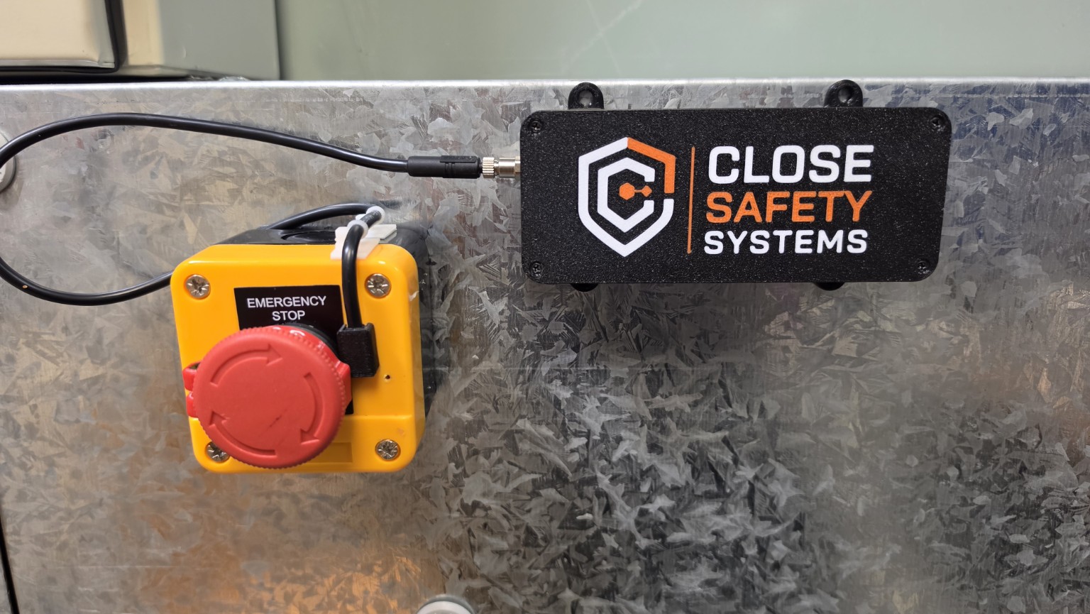 Close Safety Systems engineering demonstrator installed beside an emergency stop